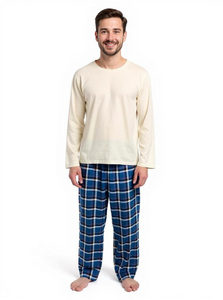 Man wearing a cream long-sleeve top and blue plaid pants on a white background